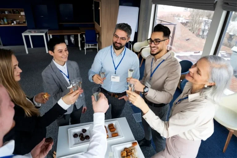 Colleagues toasting drinks at corporate networking event